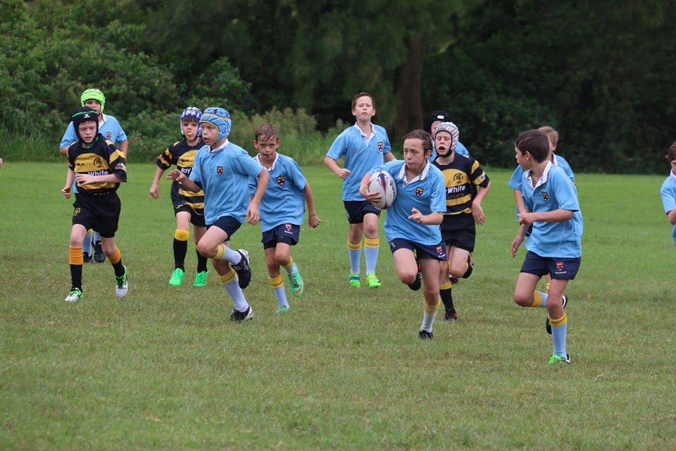 Junior player running with the ball
